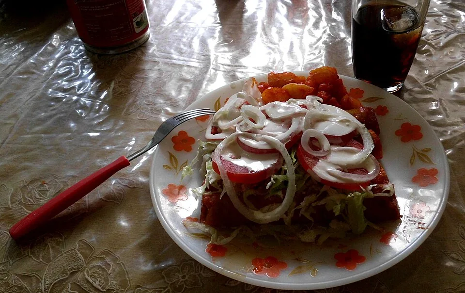 Enchiladas mineras: Tortillas pasadas por salsa de guajillo, rellenas de queso y coronadas con papa y zanahoria doradas.